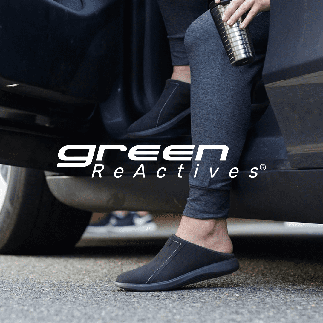 green reactives lifestyle image of a woman getting out of her car wearing dark slip on shoes