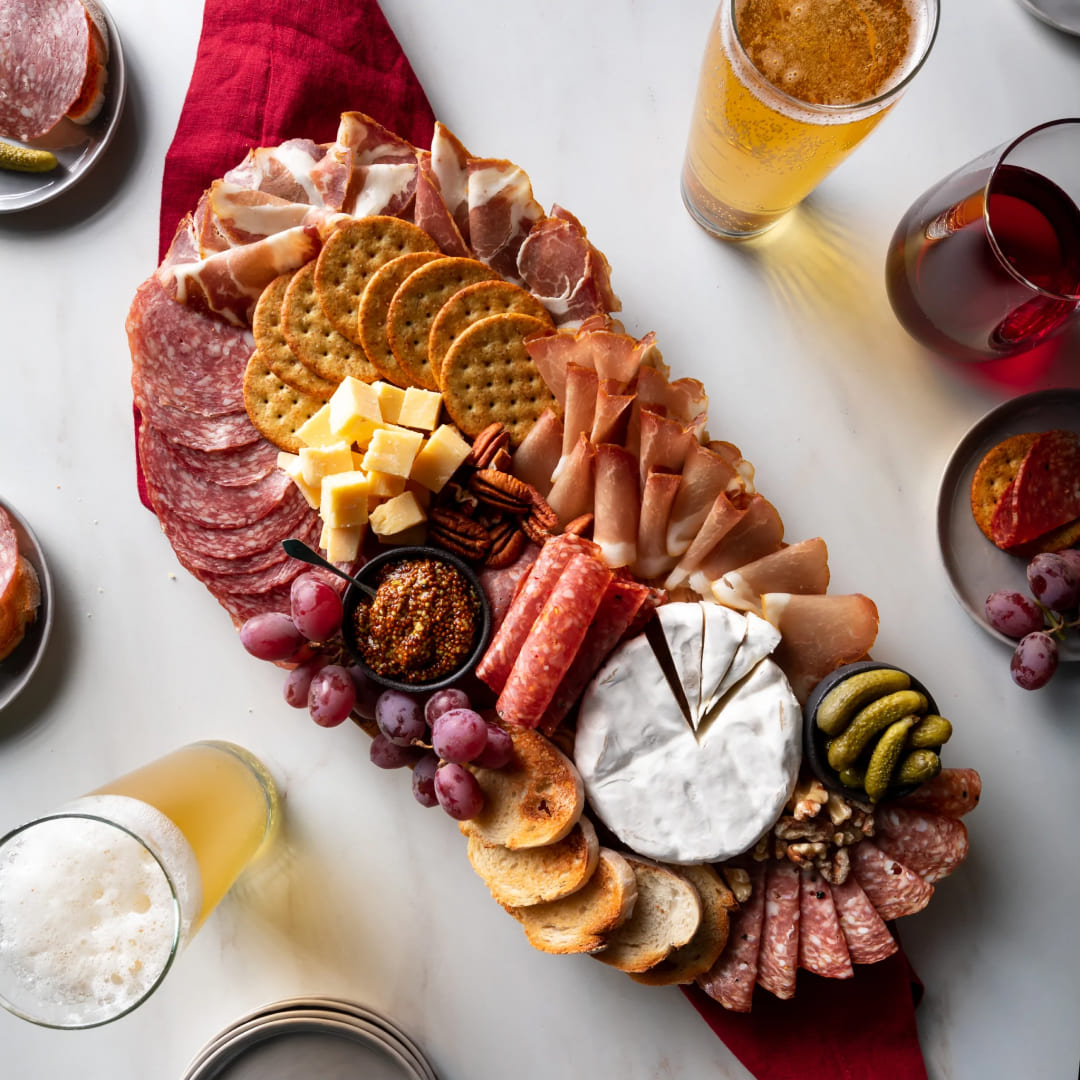 La Quercia Charcuterie Board with meats cheese crackers and fruit