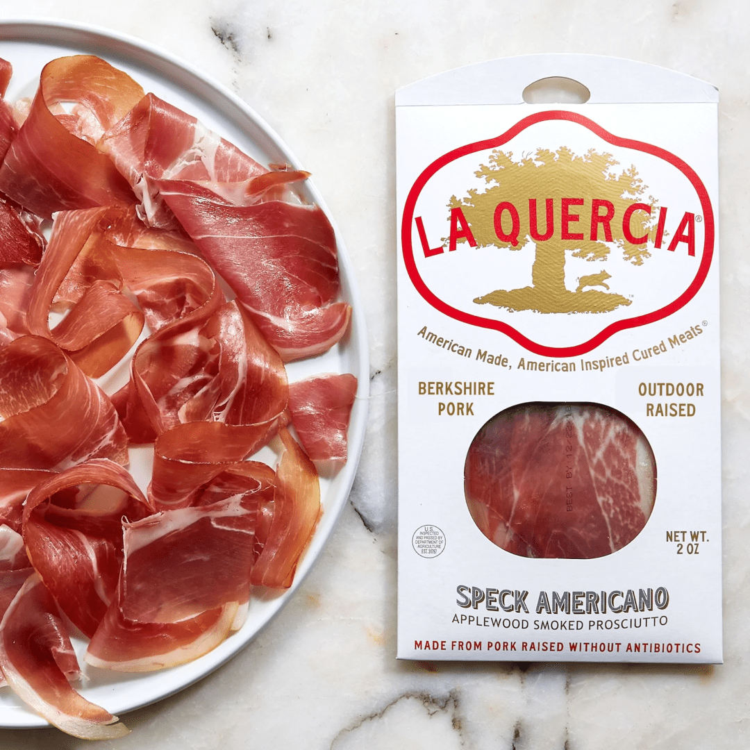 La Quercia Spek Americano on a plate next to a product in its packaging