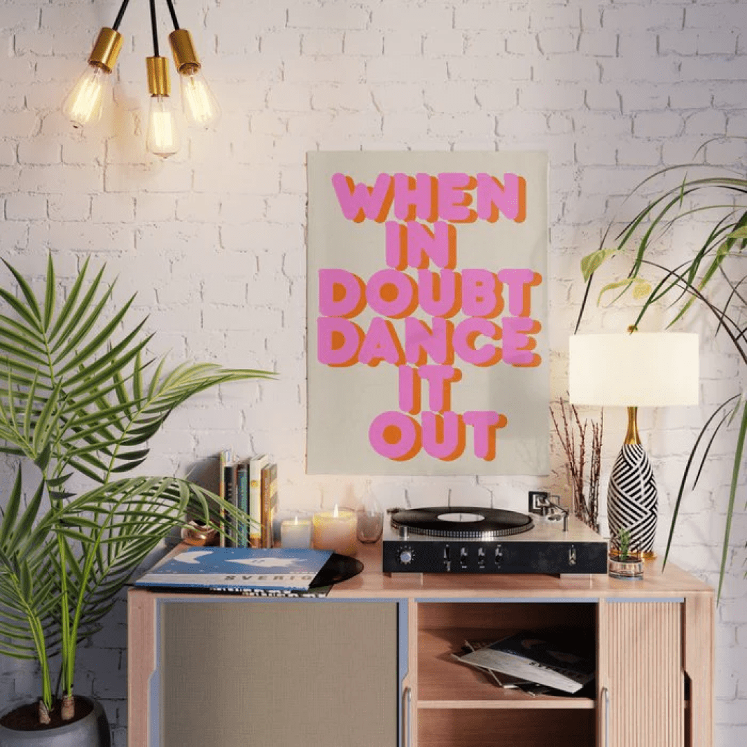 "When in doubt dance it out" poster on wall near record player